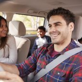 Mother turns around to her children on the back seat of car