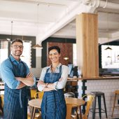 Portrait of a confident man and woman working together in a coffee shop